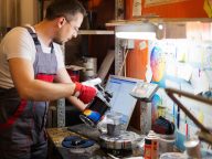 Serviceman mixing paint in a car body workshop