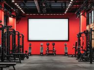 Modern gym design with blank screen for content, surrounded by w